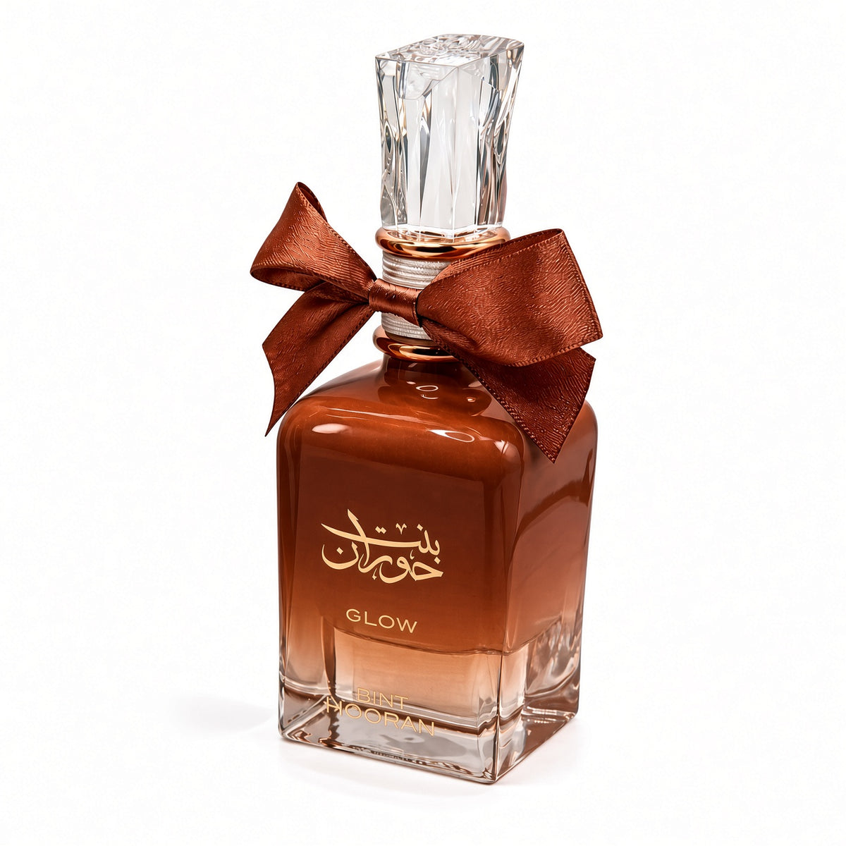 Bint Hooran Glow by Ard al Zaafaran Eau de Parfum 100ml – amber-brown gradient glass bottle with copper satin bow and clear faceted cap on white background